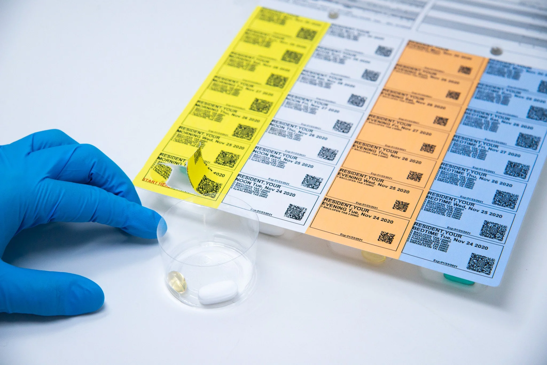 Colour-coded medication pouches sorted by day and time